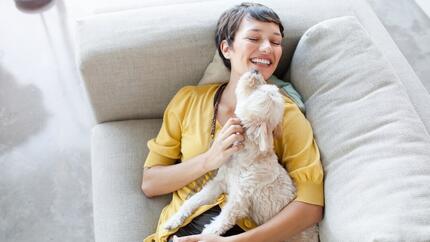 Woman smiling and hugging a dog